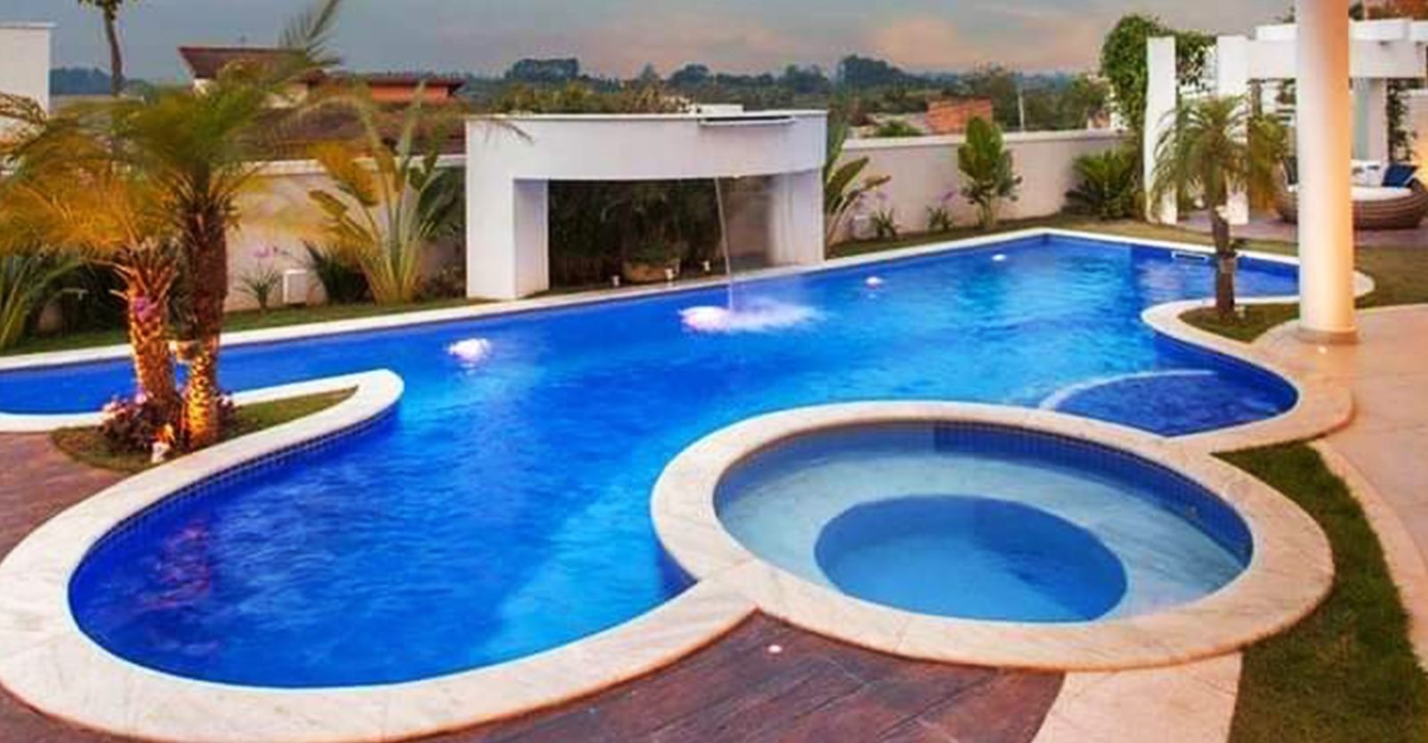 Luxury freeform swimming pool with waterfall and jacuzzi